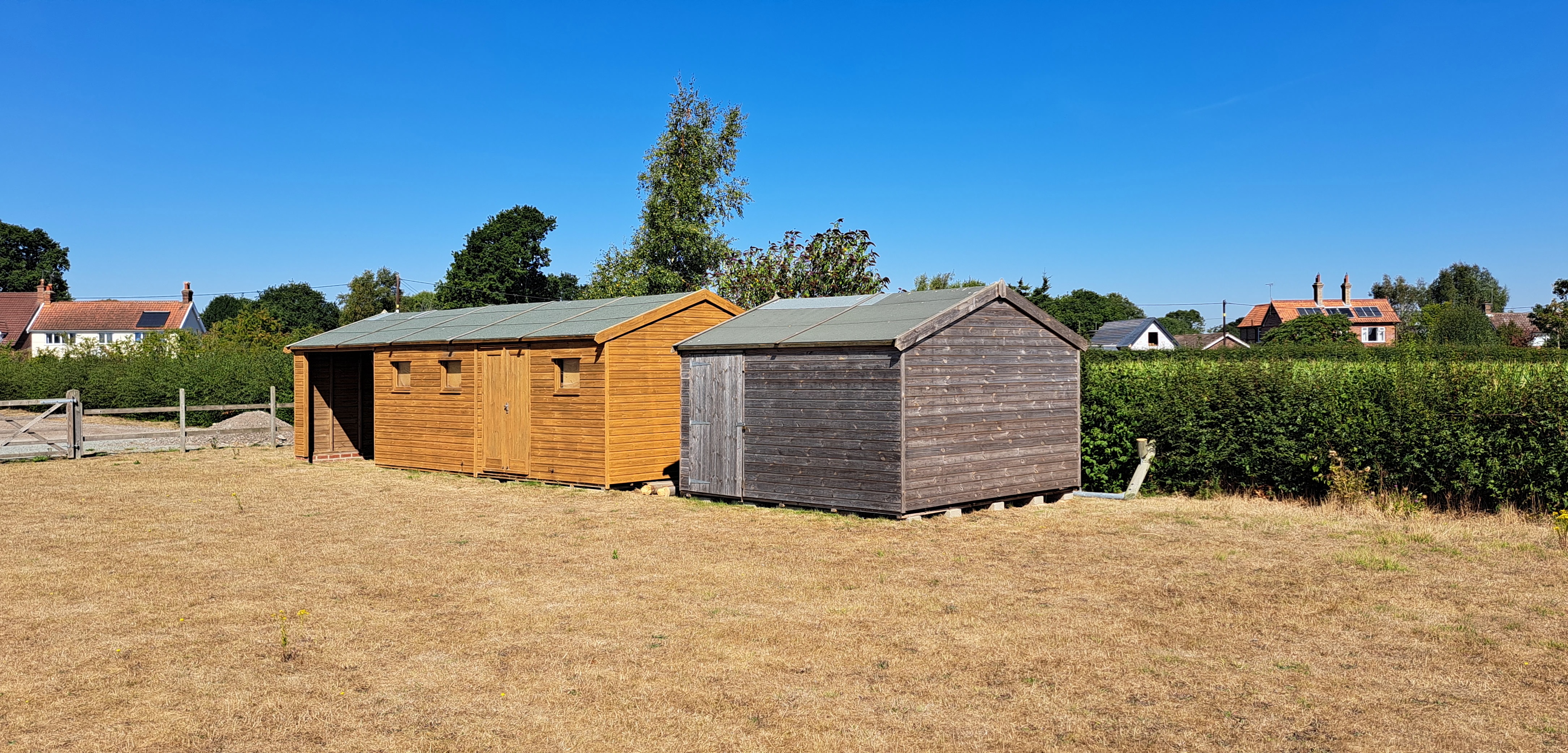 August 2022. Parched earth and wooden buildings