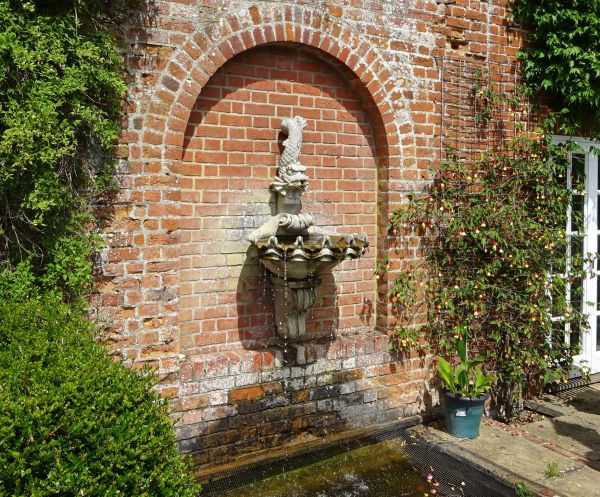 Water feature set in brick wall