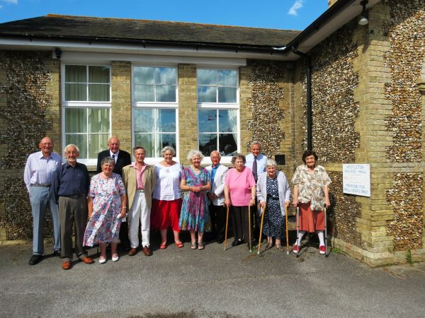 Westleton residents who celebrated their 80th birthday during the centenary year in front of the village hall.