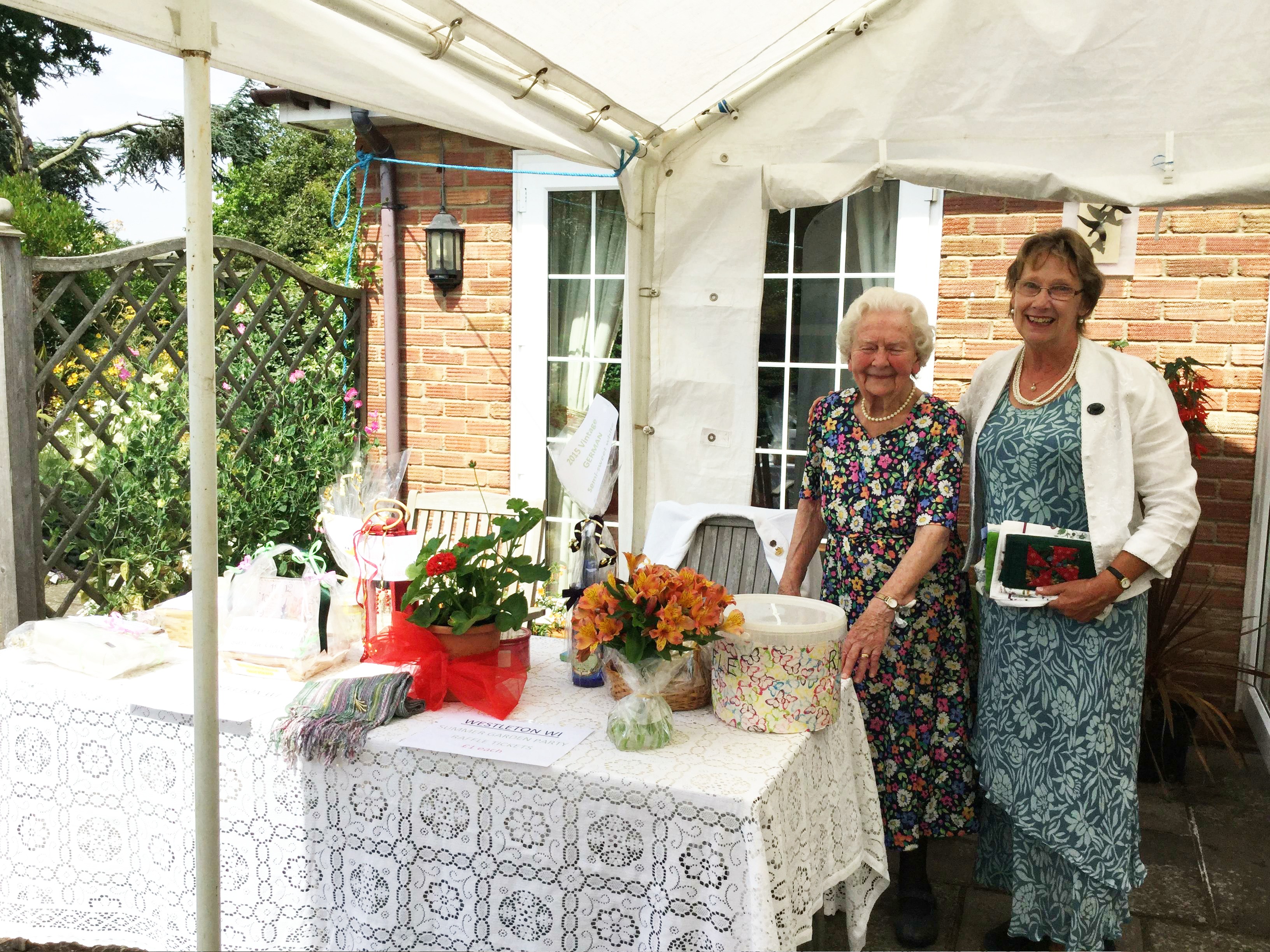 Pimms, Raffle and a Quiz in President Pat Swindell's garden. Monica and Mary at the  table.