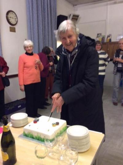 Celebrating the 90th birthday of Sheila Francis. Sheila cutting her cake.