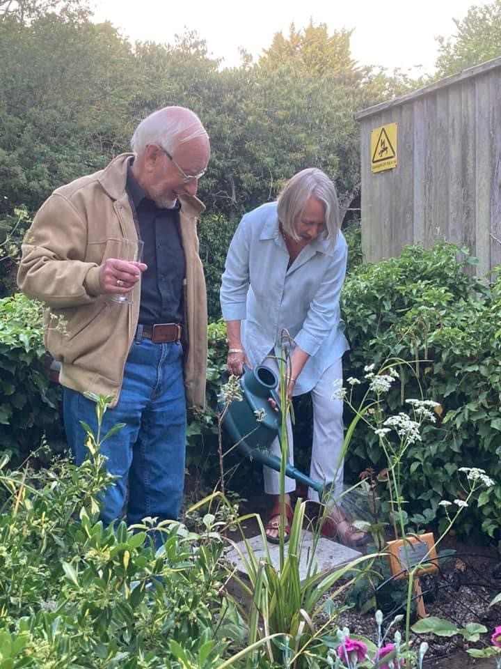 WI President and gentleman helper (he did the planting) planting and toasting rose tree in WI Jubillee Garden at Westleton Village Hall.