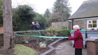 Opening the Jubilee garden, Branch President cutting tape.