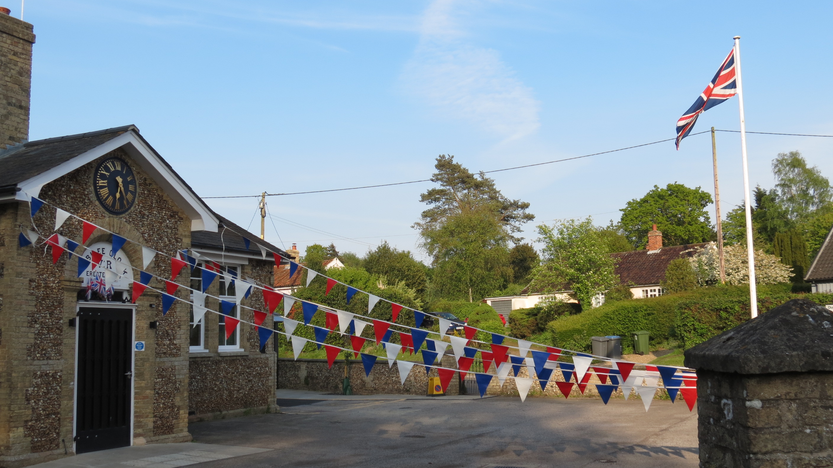 Westleton Village Hall from Darsham Road showing red, white and blue bunting and the flag pole with Union Flag flying.